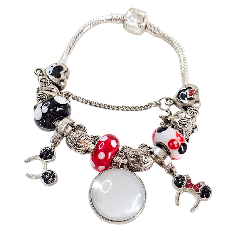 Front view of Enchanted Moments bracelet before personalization, showing its blank round photo charm, colorful beads, and dangling mouse-ear accents.