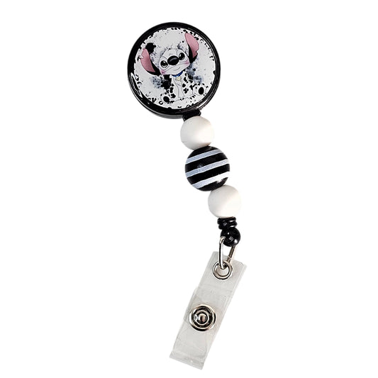 Angled view of Pawsitively Chic cartoon puppy badge reel and clear ID snap strap