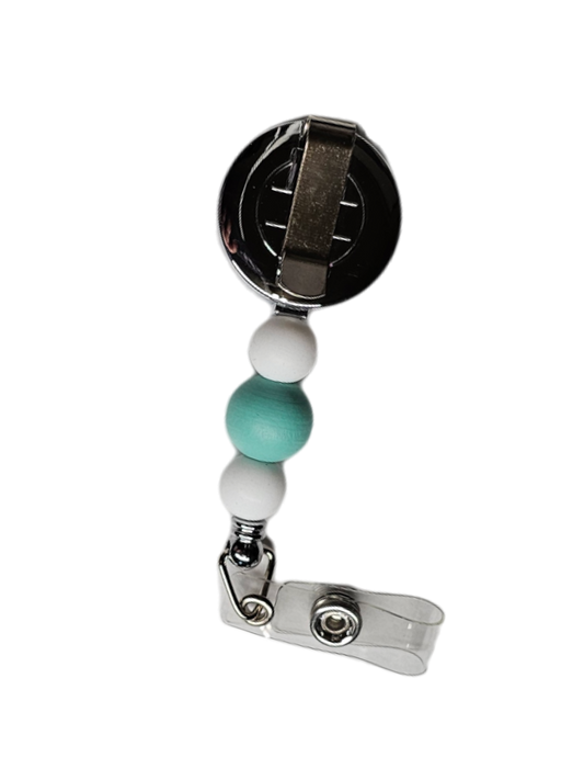 Back of Too Cute I Am badge reel showing metal attachment clip and beaded pull line