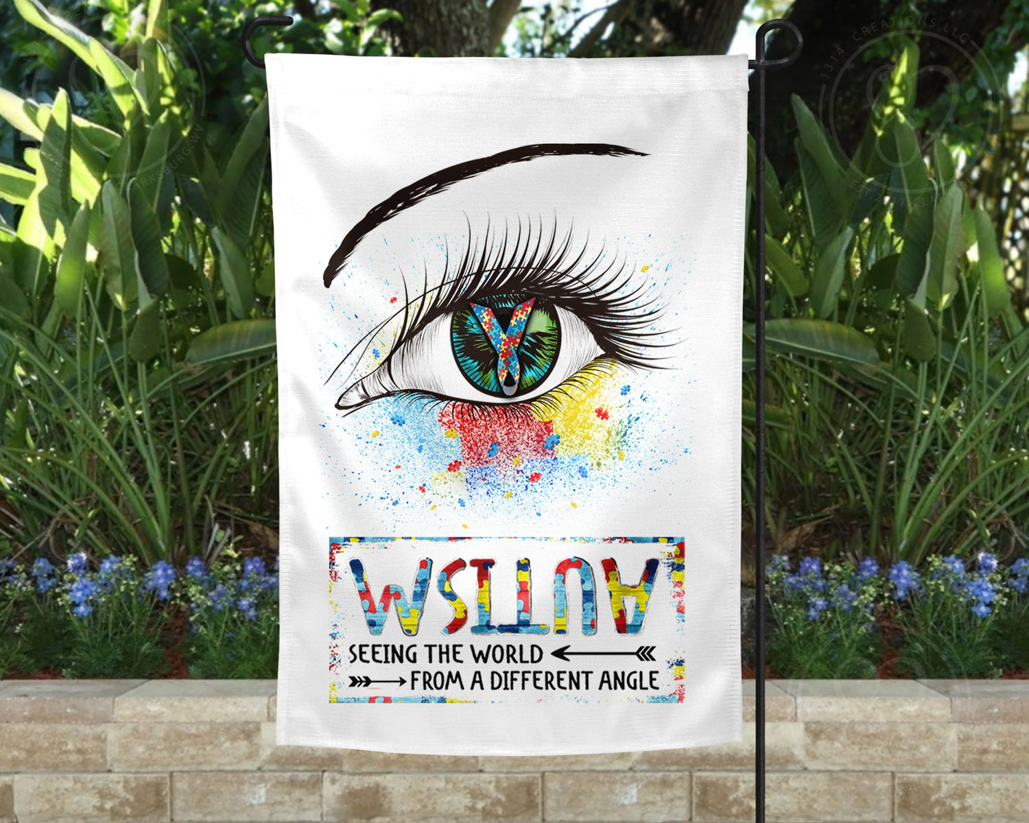 Autism awareness flag featuring an eye with the autism ribbon as the pupil. Text reads: 'AUTISM: Seeing the world from a different angle', with the word 'autism' upside down.