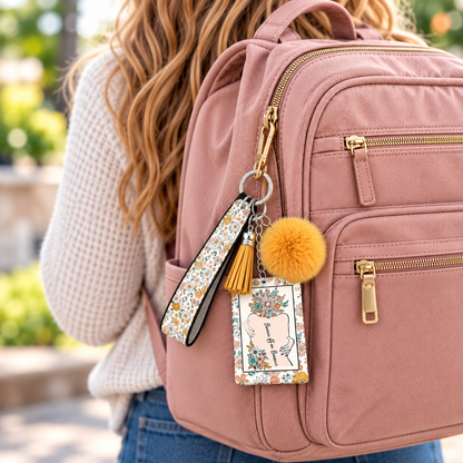 Bans Off Our Bodies wristlet keychain hanging from a pink backpack