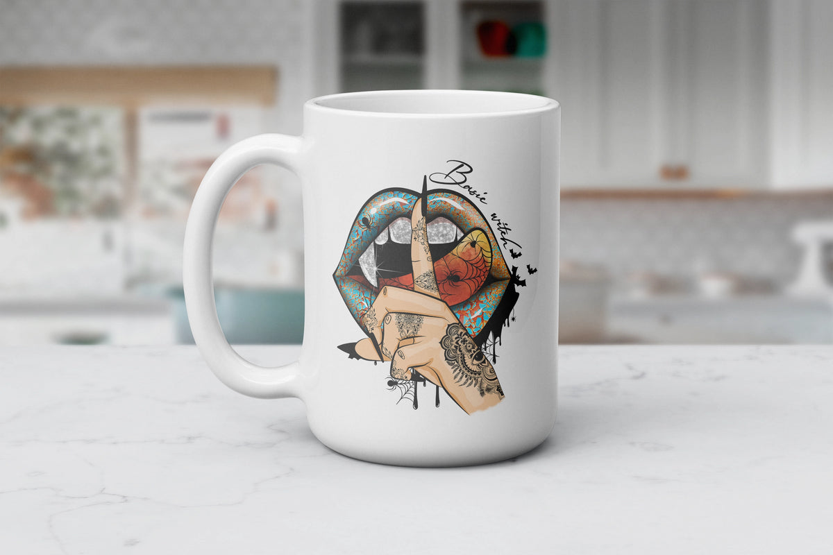 White Wicked Lips & Witchy Sips ceramic mug featuring colorful patterned lips, bats, spiderwebs and Basic Witch artwork, available in 11 oz and 15 oz sizes.