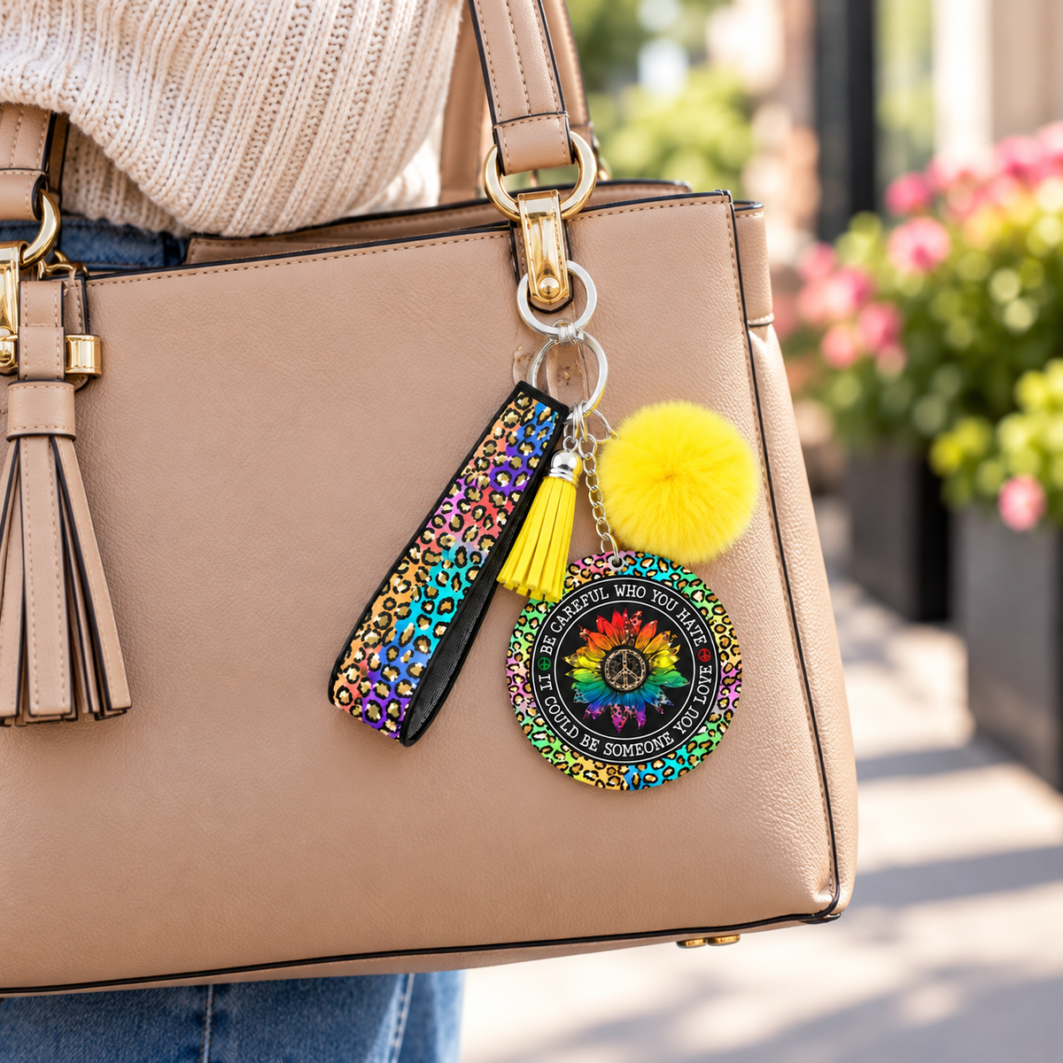 Be Careful Who You Hate wristlet keychain hanging from a purse