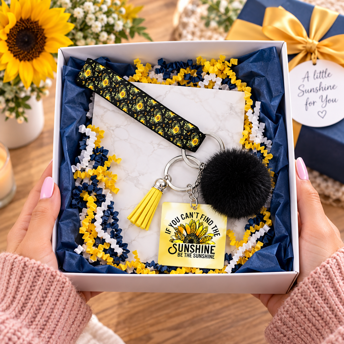 Be the Sunshine wristlet keychain arranged in a gift box