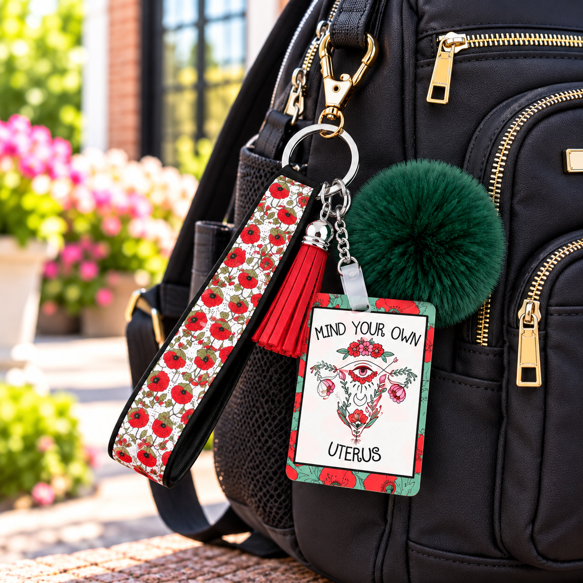 Blooms and Boundaries wristlet keychain hanging from a backpack