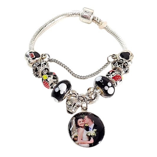 Enchanted Memories personalized photo bracelet with black, white, and red mouse-themed beads, silver-tone accents, and a round couple photo charm.