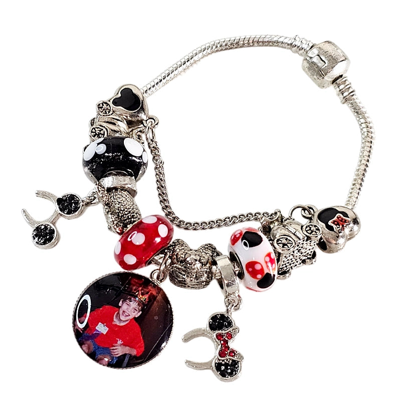 Enchanted Moments personalized photo bracelet with red, black, and white mouse-themed beads, dangling mouse-ear charms, and a round child photo charm.