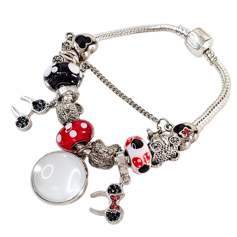Front view of Enchanted Moments bracelet before personalization, showing its blank round photo charm, colorful beads, and dangling mouse-ear accents.