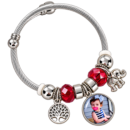 Forever in My Heart personalized photo bracelet with a silver-tone cable band, red faceted beads, tree of life charm, and elephant charm.