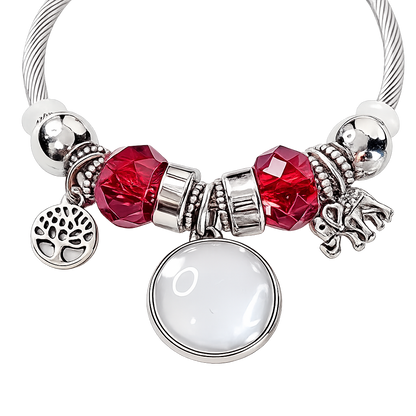 Close-up of Forever in My Heart bracelet with a blank round photo setting, red faceted beads, and silver-tone tree of life and elephant charms.