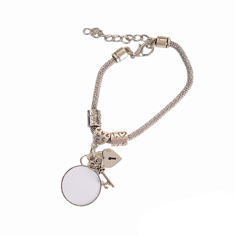 Keys to My Heart bracelet before personalization, showing a blank round photo setting, silver-tone chain, decorative beads, and extender clasp.