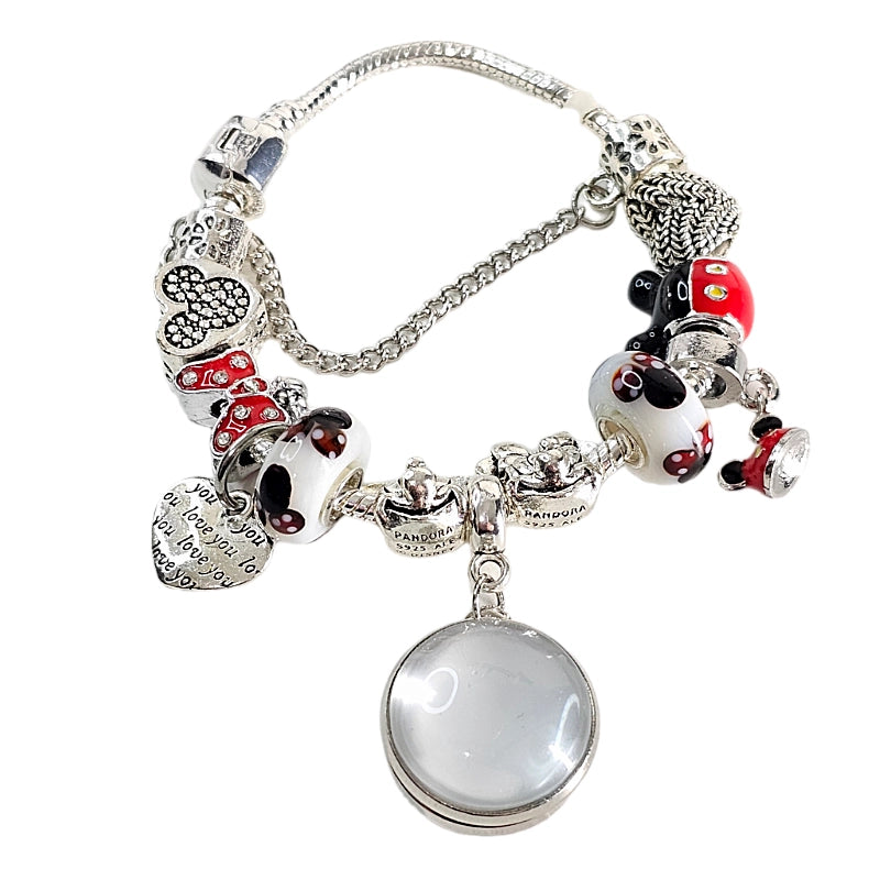 Magical Memories bracelet before personalization, with a blank round photo setting, colorful mouse-themed beads, silver-tone charms, and safety chain.