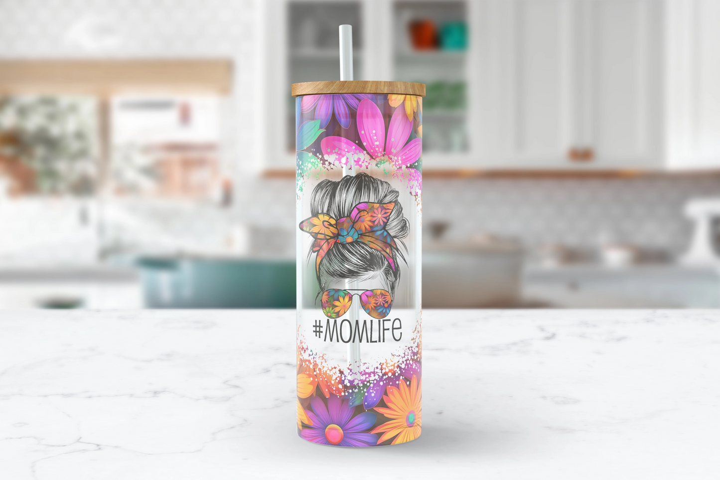 A 25oz clear glass tumbler cup featuring a bold and vibrant daisy #momlife messy bun design