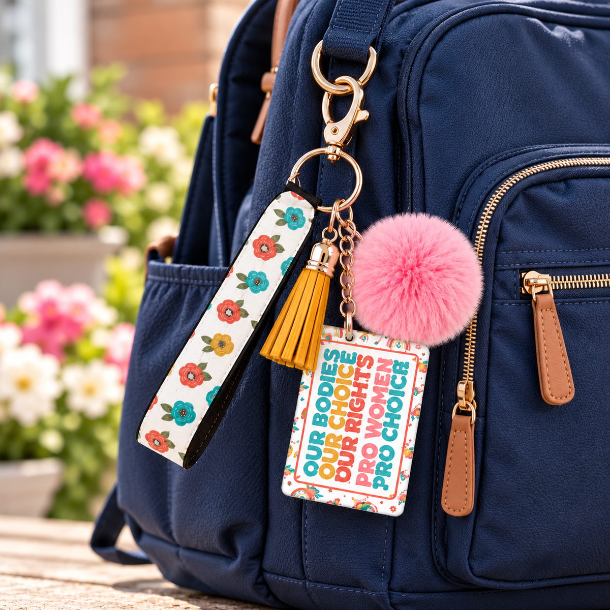 Petals Power and Choice wristlet keychain hanging from a backpack