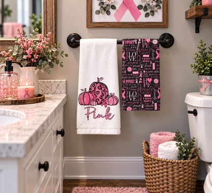 Pink pumpkin awareness towel set displayed beside a kitchen sink