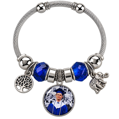 Rooted in Memories personalized photo bracelet with blue faceted beads, a silver-tone cable band, tree of life charm, and elephant charm.