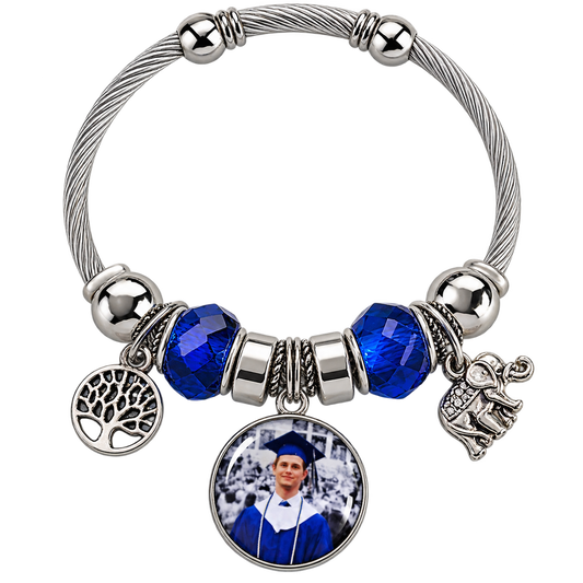 Rooted in Memories personalized photo bracelet with blue faceted beads, a silver-tone cable band, tree of life charm, and elephant charm.