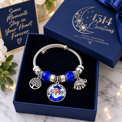 Rooted in Memories graduation photo bracelet displayed in an open navy gift box with a matching 1314 Creations branded lid.