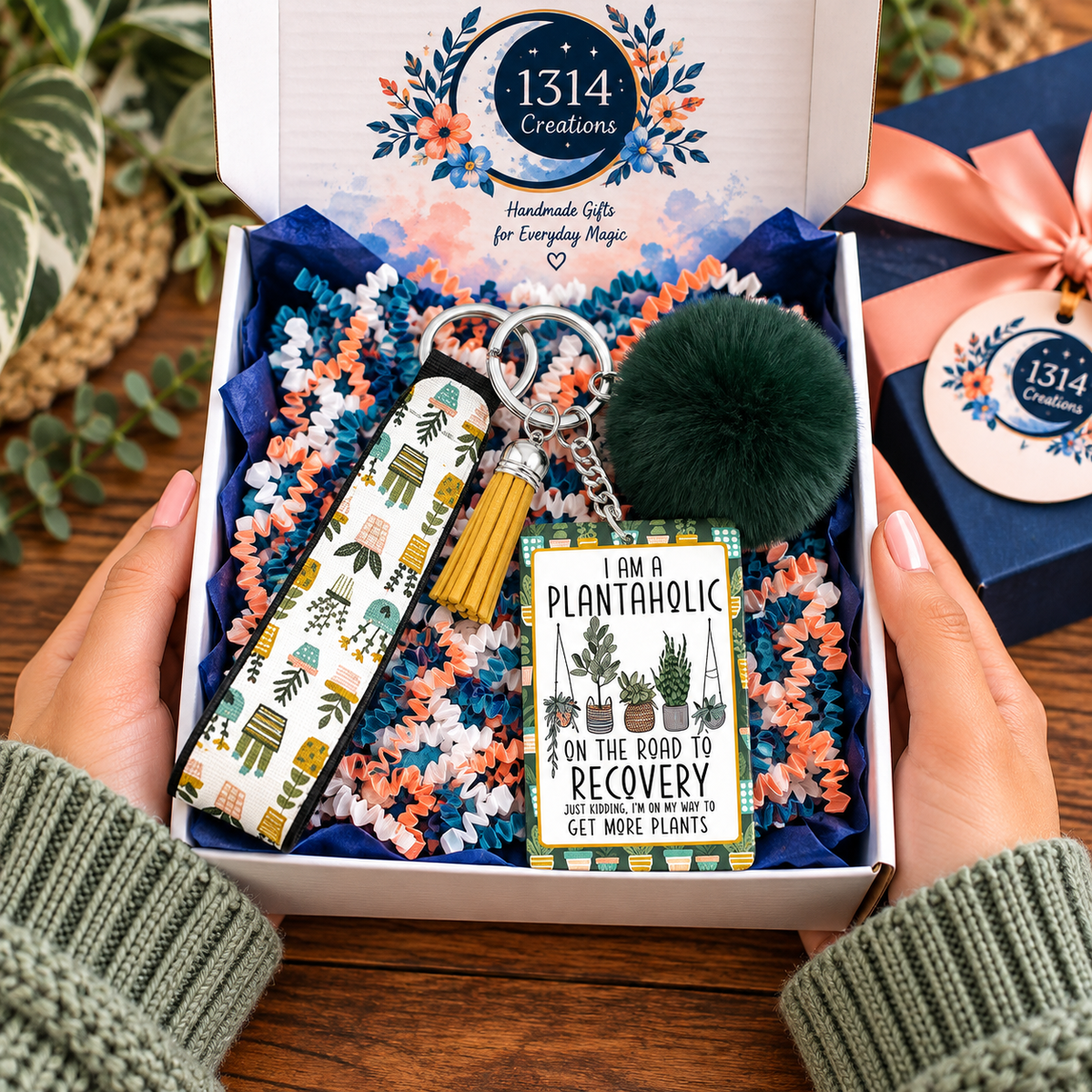 Rooted in a Little Obsession wristlet keychain arranged in a gift box