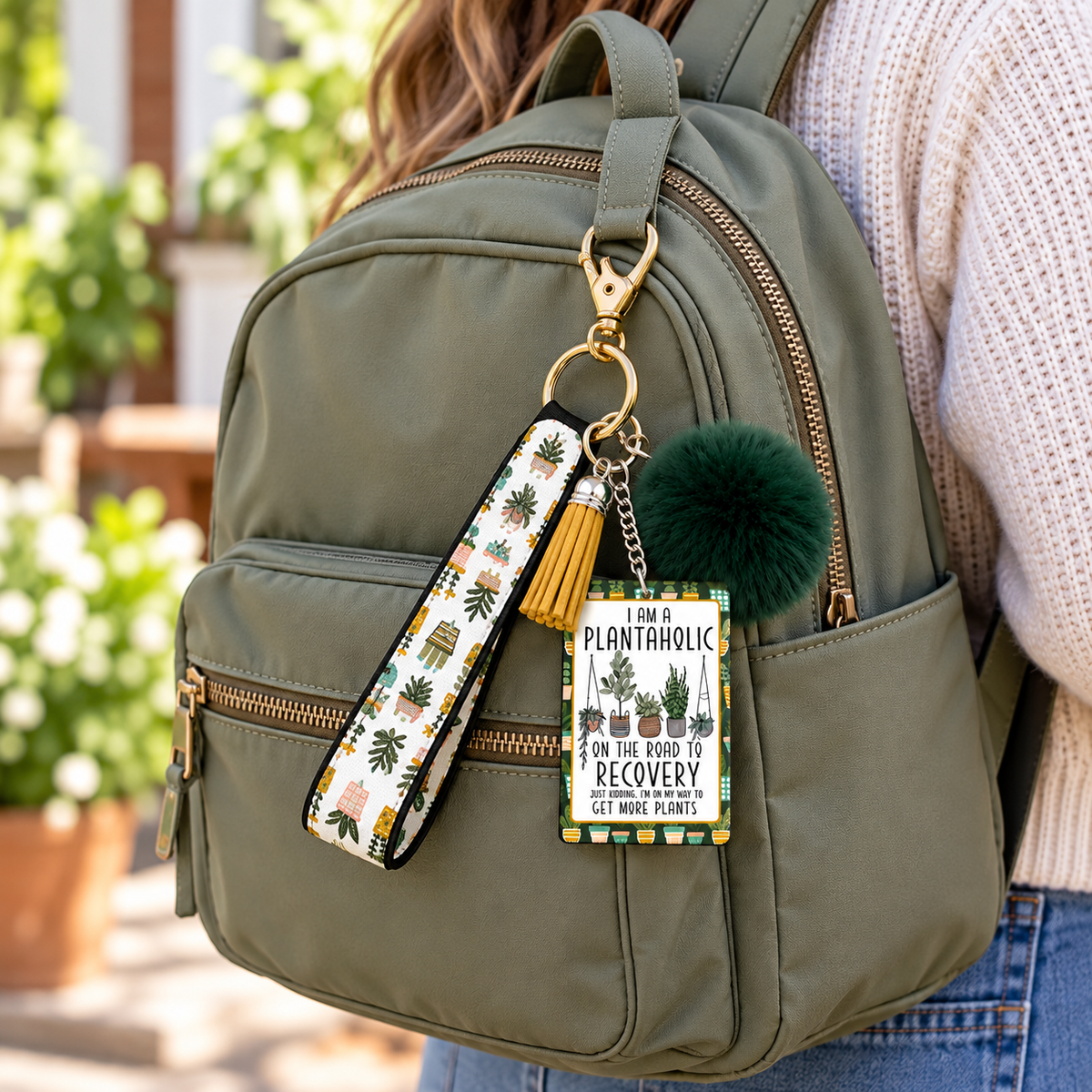 Rooted in a Little Obsession wristlet keychain hanging from a backpack