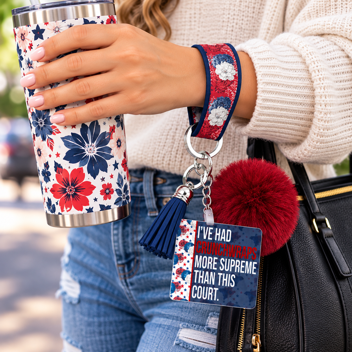 Supreme Disappointment wristlet worn while holding a tumbler
