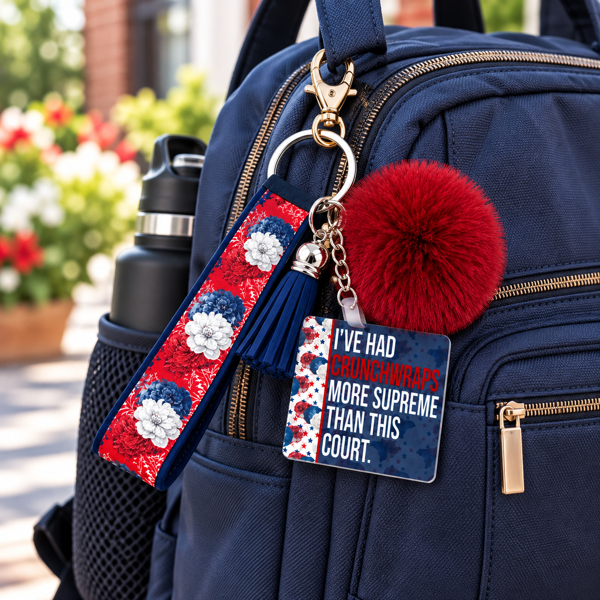 Supreme Disappointment wristlet keychain hanging from a backpack