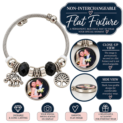 Flat fixture infographic showing a non-interchangeable photo charm on a black-and-silver bracelet