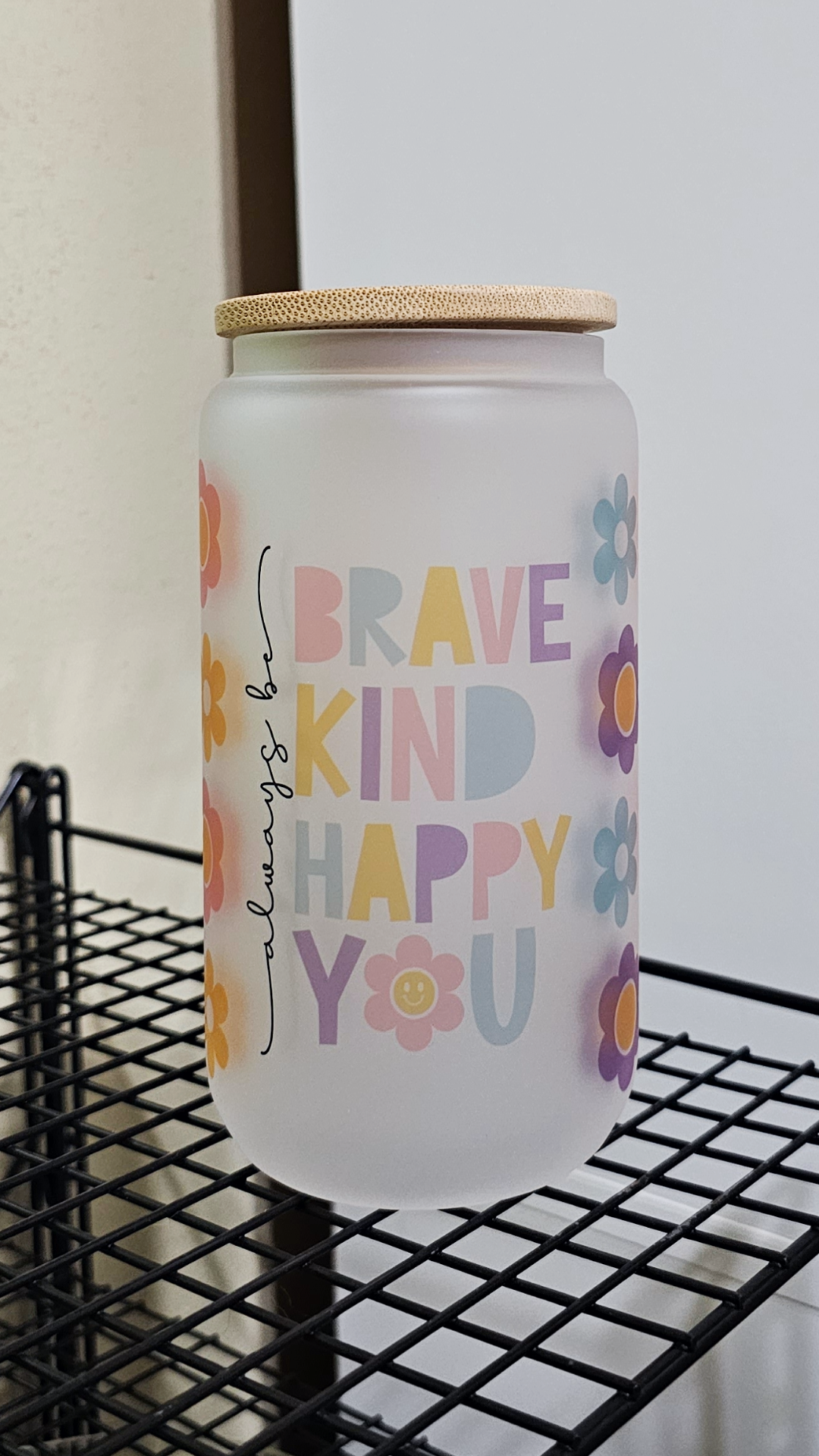 An uplifting 16oz frosted glass tumbler adorned with delicate floral patterns and the inspiring message 'Always Be You'. The tumbler features vibrant colors and a sturdy design, perfect for staying hydrated with style. 🌸 #AlwaysBeYou #GlassTumbler #PositiveVibes