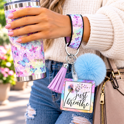 Just Breathe wristlet worn while holding a tumbler