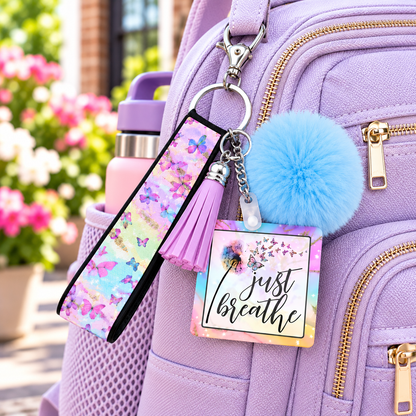Just Breathe wristlet keychain hanging from a backpack