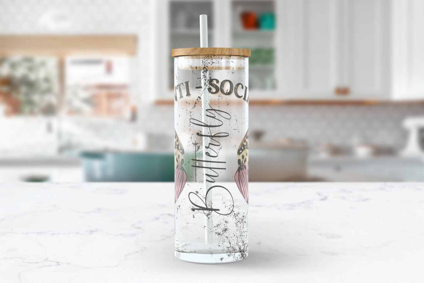 A 25oz clear glass tumbler with 'Anti Social Butterfly' printed on the side, accompanied by delicate butterfly wings