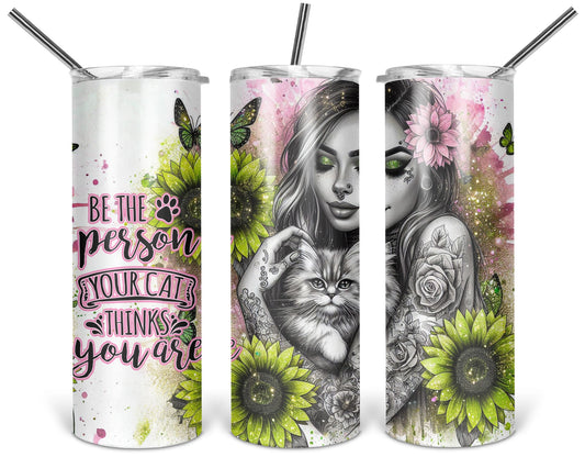Be the Person Your Cat Thinks You Are 20 oz tumbler shown from three angles with tattooed woman holding a fluffy cat with green flowers and pink accents