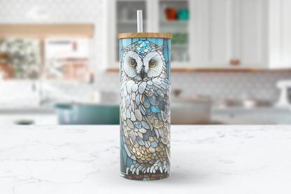  A 25oz clear glass tumbler with a blue and white stained glass design featuring an owl perched on a branch.