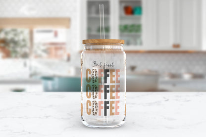 A 16oz clear glass tumbler featuring alternating solid pink, brown, and leopard print stripes meeting at the words 'but first coffee, coffee, coffee'