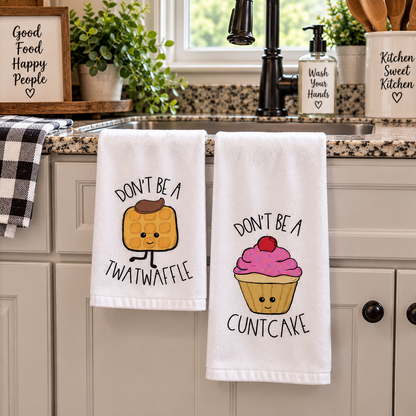 Syrup Sprinkles & Sass two-piece hand towel set featuring cowboy waffle and pink cupcake with adult-humor sayings, hanging below kitchen sink