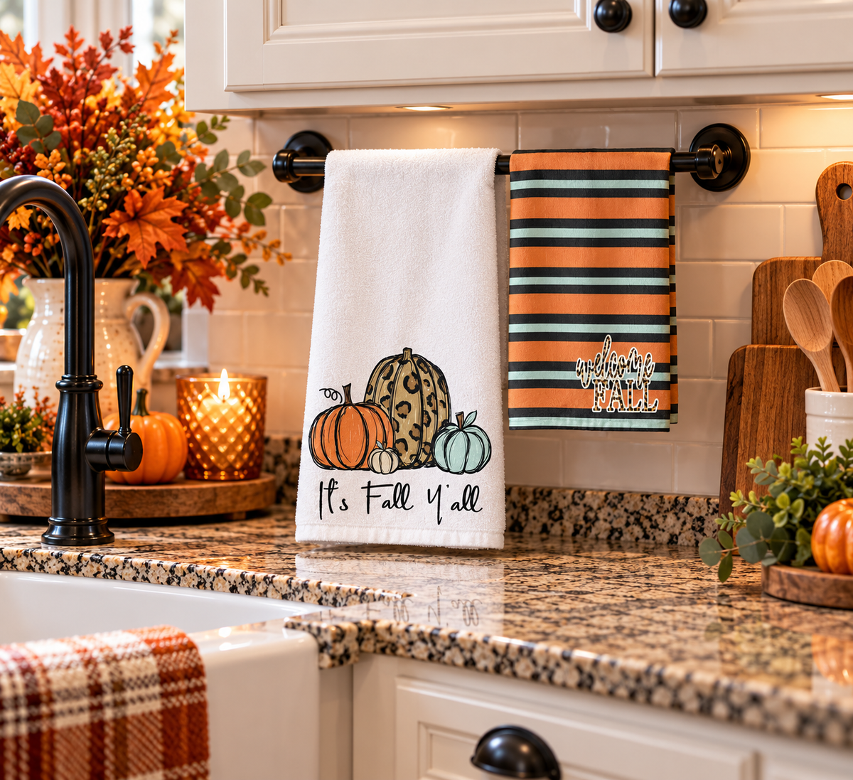 It's Fall Y'all pumpkin towel set hanging beside a kitchen sink