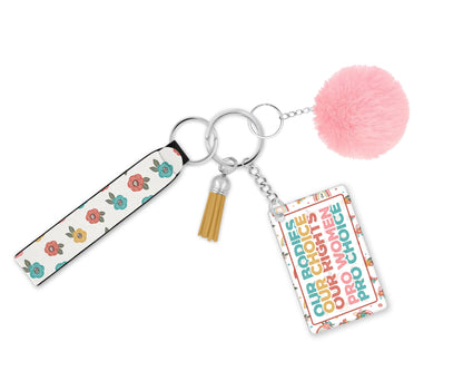 Petals Power and Choice wristlet keychain with retro floral strap, rectangular statement charm and pink pom-pom