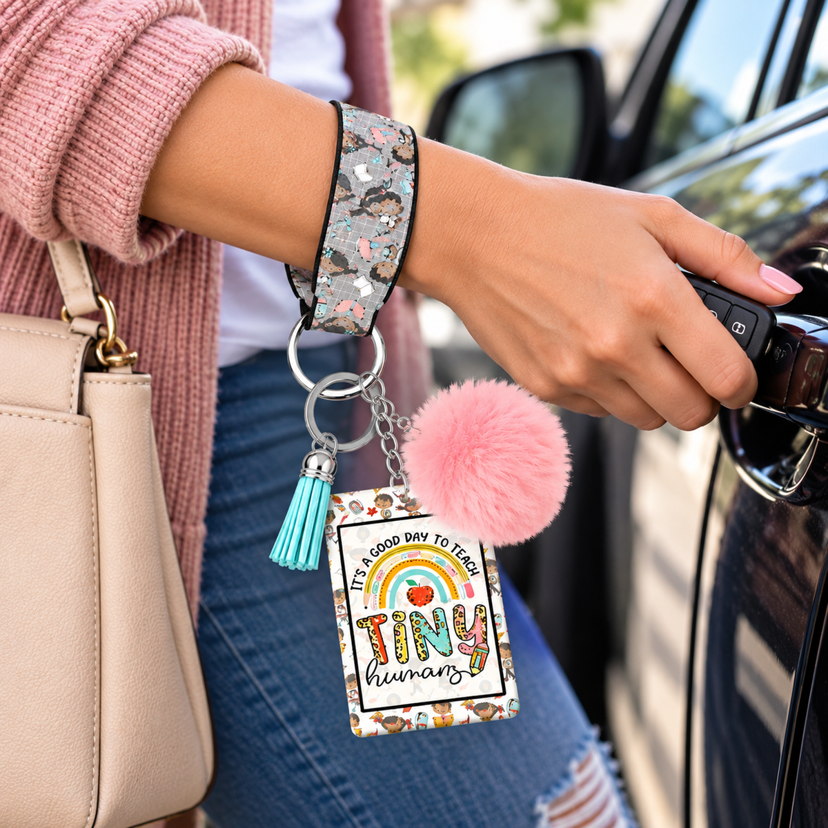 Tiny Humans keychain wristlet worn while holding car keys