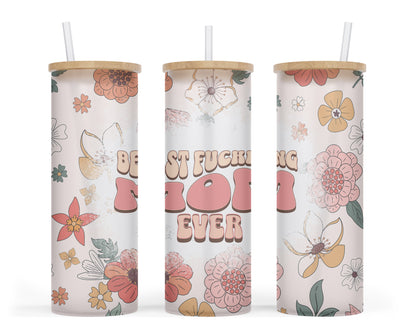 A 25 oz frosted glass tumbler with a retro floral design and the words 'best fucking mom' in a bold groovy font